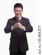 Businessman Bowing Toward Camera. Стоковое фото, агентство Ingram Publishing / Фотобанк Лори