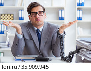 Busy employee chained to his office desk. Стоковое фото, фотограф Elnur / Фотобанк Лори