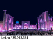 Uzbekistan. View of Registan square in Samarkand with Ulugbek madrasah, Sherdor madrasah and Tillya-Kari madrasah at night with lilac color backlight. (2019 год). Стоковое фото, фотограф Наталья Волкова / Фотобанк Лори