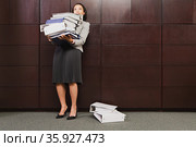 Businesswoman struggling with heavy files. Стоковое фото, фотограф Shannon Fagan / Ingram Publishing / Фотобанк Лори