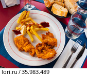 Crisp chicken nuggets with golden brown crust and french fries. Стоковое фото, фотограф Яков Филимонов / Фотобанк Лори