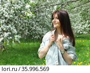 Beautiful young woman with cherry flowers in spring garden. Стоковое фото, фотограф ElenArt / Фотобанк Лори