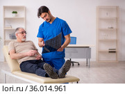Old male patient visting young male doctor radilogist. Стоковое фото, фотограф Elnur / Фотобанк Лори