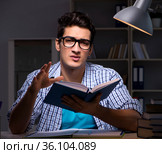 Student preparing for exams late night at home. Стоковое фото, фотограф Elnur / Фотобанк Лори