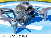 Moscow Russia - 30 may 2021: Close-up picture new aerial DJI FPV drone on fly landing pad. Top front view uav quad copter with 4K 60 fps Digital Camera and Remote control. travel in sunny summer day. Редакционное фото, фотограф Алексей Ширманов / Фотобанк Лори