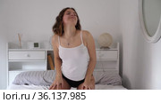 Portrait of young attractive brunette girl stretching in bed and smiling in morning. Стоковое видео, видеограф Яков Филимонов / Фотобанк Лори