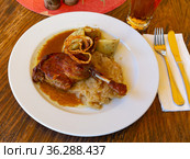 Roasted confit du canard with sauerkraut, potato dumplings and onion. Стоковое фото, фотограф Яков Филимонов / Фотобанк Лори