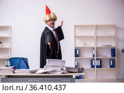 Funny young male employee magician and too much work in the office. Стоковое фото, фотограф Elnur / Фотобанк Лори