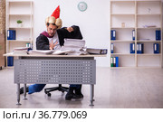 Funny young male employee magician and too much work in the office. Стоковое фото, фотограф Elnur / Фотобанк Лори