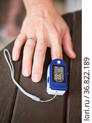 Female using oximeter for monitoring peripheral oxygen saturation , close up view. Стоковое фото, фотограф Кекяляйнен Андрей / Фотобанк Лори