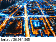 Aerial view of the night city in winter. Movement of cars on lighted streets and intersections. Стоковое фото, фотограф Евгений Ткачёв / Фотобанк Лори