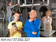 Grandson together with his grandfather solve the riddles of quest room. Стоковое фото, фотограф Яков Филимонов / Фотобанк Лори