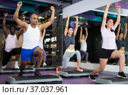 Group of people working out with steppers in fitness center. Стоковое фото, фотограф Яков Филимонов / Фотобанк Лори