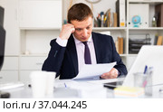 Pensive businessman working with papers. Стоковое фото, фотограф Яков Филимонов / Фотобанк Лори