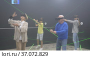 Family are wearing virtual reality goggles in the quest room. Стоковое видео, видеограф Яков Филимонов / Фотобанк Лори