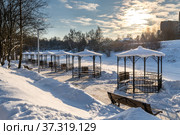 Row of metal gazebos on bank of frozen pond, Russia. Стоковое фото, фотограф Володина Ольга / Фотобанк Лори