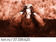 A shot of a man dressed in a gas mask, a jacket with a hood, a backpack, out of fear, defending himself, stretched out his arms in front of him. A poster on the background of grunge. Стоковое фото, фотограф Владимир Арсентьев / Фотобанк Лори
