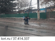 Мужчина на костылях пытается встать на люду (2022 год). Редакционное фото, фотограф Дмитрий Неумоин / Фотобанк Лори