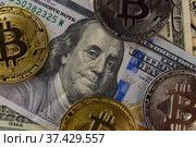 Bitcoin coins lie on dollars. Стоковое фото, фотограф Kozub Vasyl / Фотобанк Лори