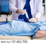 Female patient getting an injection in the clinic. Стоковое фото, фотограф Elnur / Фотобанк Лори
