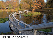 Upper pond with wooden bridge of cascade of ponds in natural historical, architectural and recreational complex "Vorontsovo Estate" of 18th century, Vorontsov Park in autumn, Moscow, Russia (2021 год). Редакционное фото, фотограф Алексей Антипов / Фотобанк Лори
