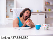 Young man waking up at home. Стоковое фото, фотограф Elnur / Фотобанк Лори