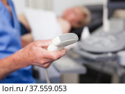 Doctor holding ultrasonic probe in hand. Стоковое фото, фотограф Яков Филимонов / Фотобанк Лори