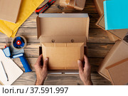 Packing products for delivery on wooden table, top view. Стоковое фото, фотограф Сергей Толмачёв / Фотобанк Лори