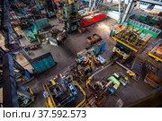 Stepnogorsk, Kazakhstan April 04, 2012: Workshop panorama of bearing production plant. Production red-hot bearing race parts on conveyor line. Редакционное фото, фотограф Alexey Rezvykh / Фотобанк Лори