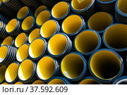 Plastic pipes production plant warehouse. Yellow PVC channelled pipes. Стоковое фото, фотограф Alexey Rezvykh / Фотобанк Лори