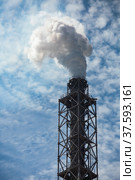 Smoking factory chimney. Plant pipe with the blue smoke on the blue sky with clouds. Стоковое фото, фотограф Alexey Rezvykh / Фотобанк Лори