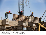 Taraz, Kazakhstan - April 25, 2012: Phosphoric fertilizers plant. Construction of reinforcement concrete foundation or basement. Using formworks and crane. Редакционное фото, фотограф Alexey Rezvykh / Фотобанк Лори