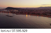Scenic aerial panoramic view of modern Barcelona cityscape on Mediterranean coast with marina at summer twilight, Spain. Стоковое видео, видеограф Яков Филимонов / Фотобанк Лори