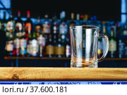 Empty beer glass on a wooden bar counter. Стоковое фото, фотограф Сергей Толмачёв / Фотобанк Лори