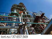 Grey oil distillation towers (refining columns) and pipelines at the oil refinery plant on blue sky background. Taraz city. Kazakhstan. Стоковое фото, фотограф Alexey Rezvykh / Фотобанк Лори
