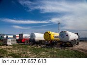 Jambyl region, Kazakhstan - April 25 2012: Oil refinery and gas processing plant. Oil tanker car on parking of filling station. Blue sky with clouds. Редакционное фото, фотограф Alexey Rezvykh / Фотобанк Лори