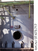 Petrochemical plant. Close-up of oil distillation tower (refining column). close up with shadows and manhole. Стоковое фото, фотограф Alexey Rezvykh / Фотобанк Лори