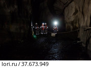 Khromtau, Aktobe region, Kazakhstan - May 06 2012: Gold extraction. Group of miners in underground gallery. Редакционное фото, фотограф Alexey Rezvykh / Фотобанк Лори