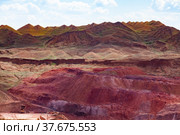 Heaps of empty rocks in color aluminium ore quarry. Bauxite clay open cast (open cut) mining. Blue sky with clouds. Стоковое фото, фотограф Alexey Rezvykh / Фотобанк Лори