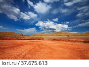 Arkalyk/Kazakhstan: Aluminium ore mining and transporting. Bauxite clay. Orange dump truck (quarry truck) Hitachi running. Blue sky with white clouds background. Стоковое фото, фотограф Alexey Rezvykh / Фотобанк Лори