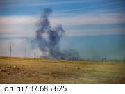 Panorama view on steppe and explosion. Coal extraction quarry in Kazakhstan. Black smoke on blue sky background. Стоковое фото, фотограф Alexey Rezvykh / Фотобанк Лори
