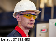 Ekibastuz, Kazakhstan - May 28, 2012. Explosive material production plant for coal quarry mining. Portrait of young technologist engineer. Редакционное фото, фотограф Alexey Rezvykh / Фотобанк Лори