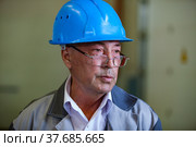 Ekibastuz, Kazakhstan - May 28, 2012. Explosive material production plant for coal quarry mining. Portrait of senior technologist engineer. Редакционное фото, фотограф Alexey Rezvykh / Фотобанк Лори