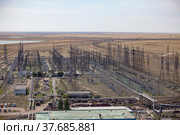 GRES-1 thermal power station. Transformer and distribution substation. Steppe and lake on background, blue sky.Aerial view. Ekibastuz, Pavlodar region, Kazakhstan. Стоковое фото, фотограф Alexey Rezvykh / Фотобанк Лори