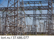 Pylons and cables. Electric transformer and Distributing substation close-up. Blue sky background. Стоковое фото, фотограф Alexey Rezvykh / Фотобанк Лори