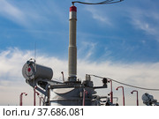 Electric transformer and ceramics isolators close-up. Distribution substation of electricity. Blue sky with light clouds background. Стоковое фото, фотограф Alexey Rezvykh / Фотобанк Лори