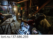 Welder works on armature valve, right. Works on power plant boiler assembling. (2012 год). Редакционное фото, фотограф Alexey Rezvykh / Фотобанк Лори