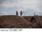 Almaty region, Kazakhstan - June 04, 2012: Mining and processing plant of Altynalmas company. Chemist use sodium cyanide NaCN for gold refining. Hazmat suits and gas masks. Стоковое фото, фотограф Alexey Rezvykh / Фотобанк Лори
