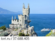 Castle Swallow's Nest on a rock at Black Sea, Crimea, Russia. It is a symbol and tourist attraction of Crimea (2019 год). Редакционное фото, фотограф Алексей Кокоулин / Фотобанк Лори