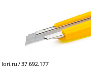 The yellow stationery knife isolated on white background. Стоковое фото, фотограф Сергей Толмачёв / Фотобанк Лори